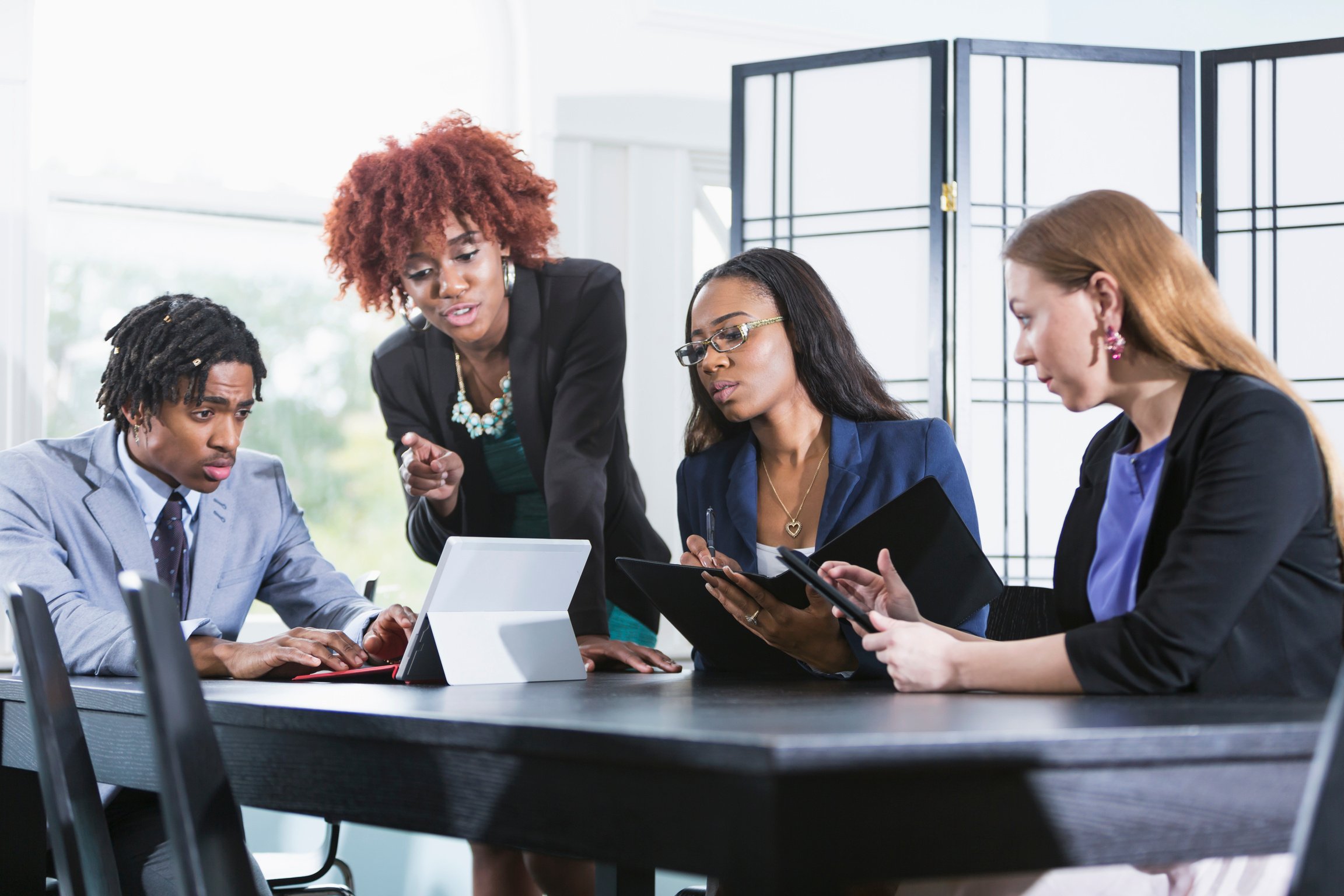 Multiracial business meeting, black woman in charge